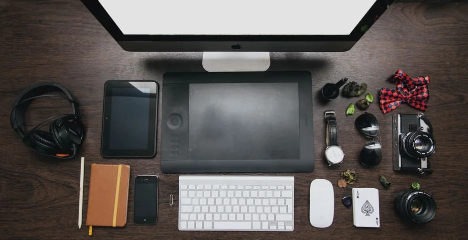 Dual monitors on a desk, showcasing web design in a modern office setting.